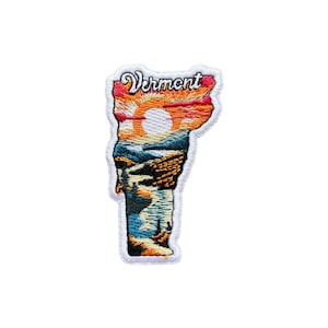 May include: Embroidered patch in the shape of Vermont, depicting a sunset over mountains and a lake. The word "Vermont" is stitched in a cursive font. The patch has a white border.