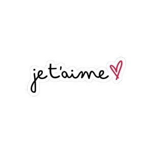 May include: A white sticker with the French phrase "je t'aime" in black cursive script, meaning "I love you." A small red heart is next to the text, adding a touch of color to the design.