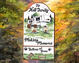 May include: A wooden sign with a painted image of a camper, a campfire, and two chairs. The text on the sign reads "The Hill Family Making Memories Buttons and Beau".
