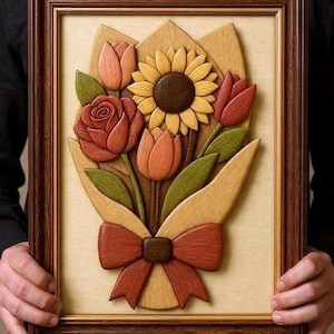 May include: A wooden framed relief carving of a bouquet of flowers. The bouquet includes a sunflower, tulips, and a rose, all in shades of orange, red, and yellow. The bouquet is wrapped in a light brown paper and tied with a red bow.