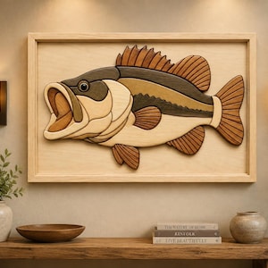 May include: A rectangular wooden wall art piece featuring a layered, multi-toned wood inlay of a largemouth bass fish. The fish is constructed from various shades of natural wood, showcasing a detailed open mouth, fins, and tail within a frame.