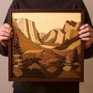 May include: A framed wooden landscape artwork depicting mountains and trees. The piece is made from different shades of brown wood, giving a layered appearance. The frame is dark brown. The artwork is a rustic style, suitable for home decor.