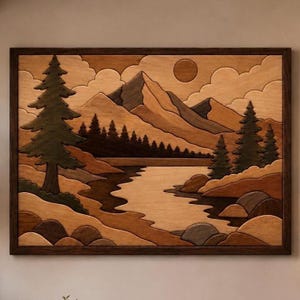 May include: Wooden landscape artwork depicting a mountain range, lake, and trees. The piece uses various shades of brown and tan wood to create depth. A dark brown frame surrounds the artwork, which depicts a sun and clouds.