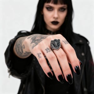 May include: A white ceramic mug with a black handle and the text "But First, Coffee" in a black, bold font. The mug is on a white surface. The mug is approximately 10 cm tall.