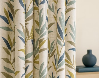 May include: Cream-colored curtain panel with a repeating pattern of stylized leaves in shades of blue, green, and brown. The leaves are arranged vertically, creating a natural, organic design. The curtain is made of a textured fabric.