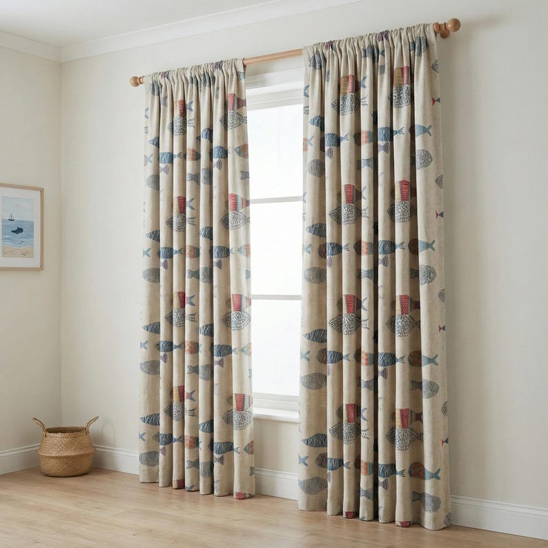 May include: Beige curtains with a repeating pattern of blue, red, and gray fish. The curtains are hanging on a wooden rod in front of a window. The room has a light, airy feel.
