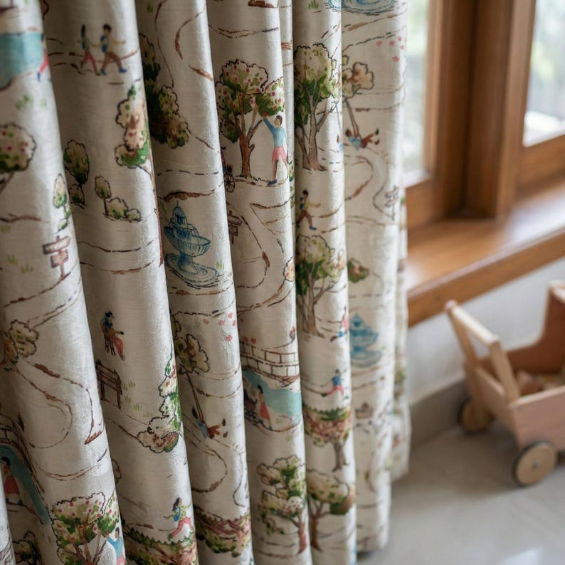May include: Cream-colored curtains with a whimsical park scene printed on them. The design features trees, pathways, fountains, and figures of people. The curtains are hanging near a wooden window frame.