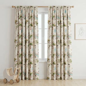 May include: Two beige curtain panels with a whimsical illustrated design of a park scene, featuring trees, bridges, and figures in shades of green, blue, and brown. The curtains are hanging on a wooden rod.