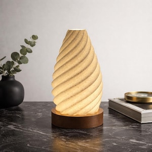 May include: A set of three ceramic mugs with a speckled, matte finish. The mugs are in shades of cream, light gray, and dark gray. Each mug has a simple, minimalist design, perfect for coffee or tea.