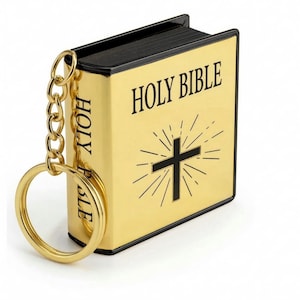 May include: A gold-colored keychain shaped like a miniature book, with the words "HOLY BIBLE" printed on the cover. A black cross with radiating lines is also on the cover. The keychain has a gold chain and ring.