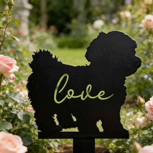 May include: Black metal garden stake in the shape of a dog, with the word "Love" in a cursive font. The dog silhouette is set against a background of pink roses and greenery.