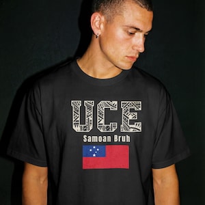 May include: Black t-shirt with the word "UCE" in a decorative font, "Samoan Bruh" below, and the Samoan flag. The flag is red with a blue rectangle in the upper left corner containing five white stars.
