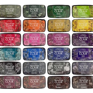 May include: Twenty-four ink pads in various colors with the text "VersaFine CLAIR" and "TSUKINEKO" on each pad.