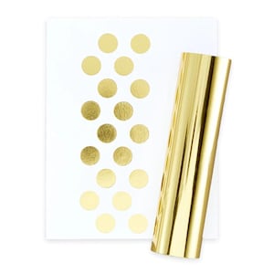 Könnte beinhalten: Ein Blatt weißes Papier mit goldenen Punkten und eine Rolle goldene Folien Geschenkpapier.