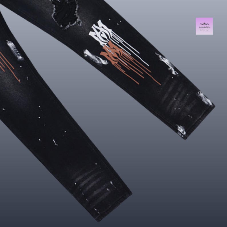 May include: Black denim jeans with distressed details and paint splatter accents. The jeans feature a unique design on the leg with white and brown paint strokes. The overall style is edgy and modern.