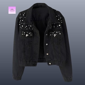 May include: A handmade wooden sign with the text "Welcome" in a playful font. The sign is painted white with a distressed finish, and features a decorative floral design in shades of pink and green. It measures approximately 12 inches wide.