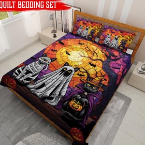 May include: A quilt bedding set featuring a Halloween theme with three cats dressed as a mummy, a ghost, and a witch. The design includes a large yellow moon, bare tree branches, bats, and pumpkins against a purple and orange background.