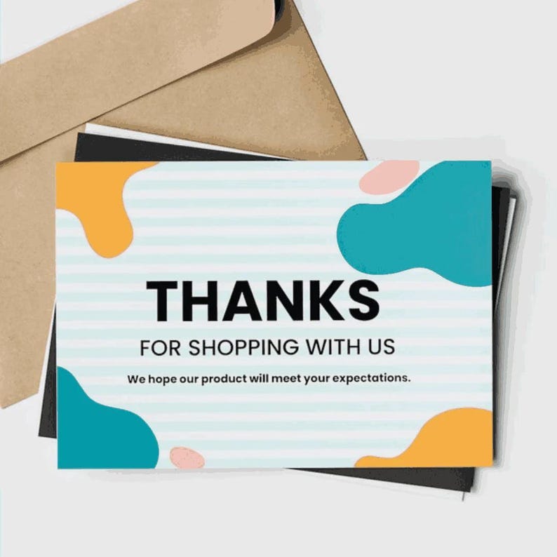 May include: A stack of thank you cards with a kraft paper envelope. The card has a light blue striped background with teal and orange abstract shapes. The words "THANKS FOR SHOPPING WITH US" are printed in bold black font.
