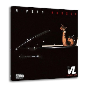 May include: A canvas print featuring the album cover for "Victory Lap" by Nipsey Hussle. The image shows a person in a car with their arm raised. The album title is at the top, and the "Parental Advisory" label is visible.