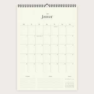Könnte beinhalten: Ein Wandkalender für Januar 2027 mit cremefarbenem Hintergrund und schwarzer Schrift. Der Kalender zeigt ein Raster für den Monat, einen Bereich für Prioritäten und Notizen am unteren Rand sowie eine kleine Vorschau für Februar 2027.