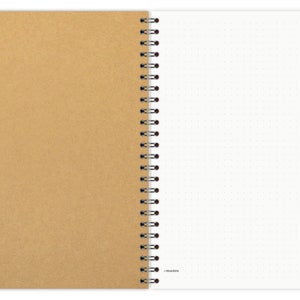 May include: A brown kraft paper notebook with a white dotted page and a black and red coil binding. The notebook has the word "mamu" printed on the bottom of the white page.