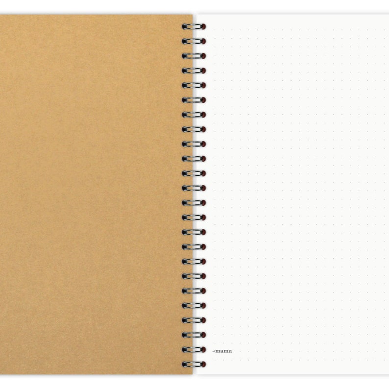May include: A brown kraft paper notebook with a white dotted page and a black and red coil binding. The notebook has the word "mamu" printed on the bottom of the white page.
