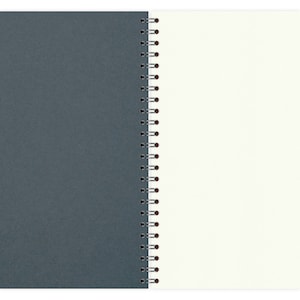 May include: A gray and white spiral bound notebook with a dark gray cover and white pages.
