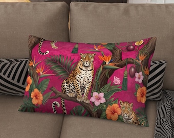 May include: A rectangular decorative pillow with a vibrant pink background featuring a leopard, tropical flowers, and foliage. The pillow has a jungle theme with orange, pink, and green accents, creating a bold and colorful design.