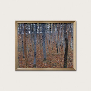 May include: A framed art print of a forest scene. The artwork depicts numerous slender birch trees with gray and white bark, set against a backdrop of fallen autumn leaves in shades of brown and orange. The frame is gold.
