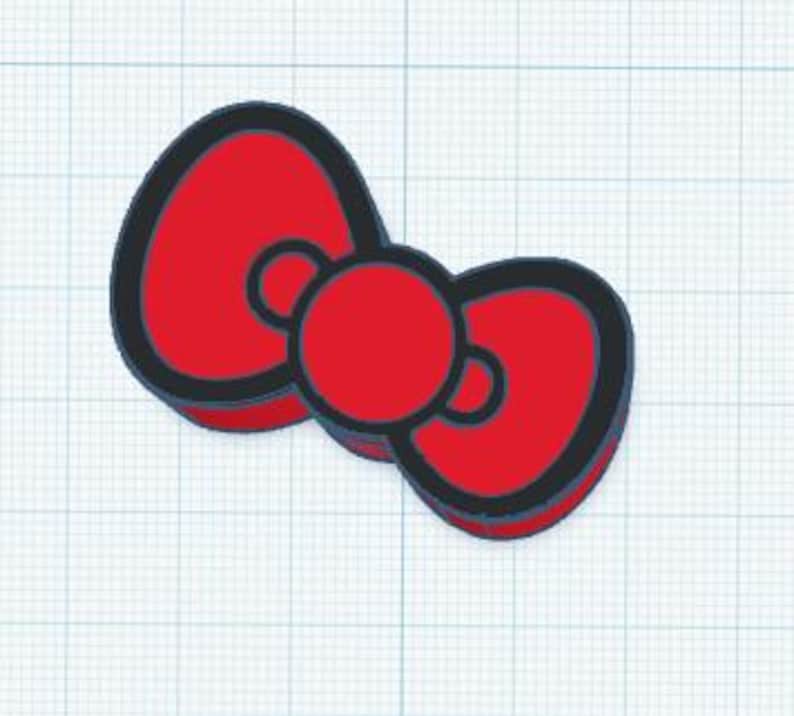 May include: A red bow with a black outline and a red center. The bow is a simple, stylized design, likely for decorative purposes. The background is a grid pattern.