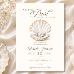 May include: A cream-coloured baby shower invitation card featuring a watercolour illustration of an open seashell with a single pearl inside. The text reads A LITTLE PEARL IS ON THE WAY, followed by event details for Emily Johnson on September 22.