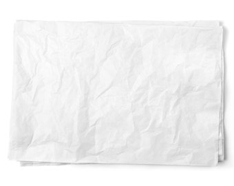 May include: A crumpled sheet of white paper. The paper is wrinkled and has a textured surface.