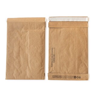 May include: Two brown paper mailing envelopes with a white strip across the top. The envelope on the right has the text "Please recycle this mailer with your mixed paper. Pull Tab to Open." and "ECODENCLOSE" printed on the bottom.