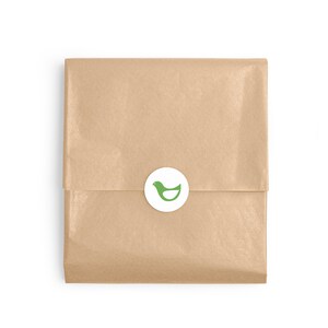 May include: A brown paper package with a white circle sticker featuring a green bird logo.