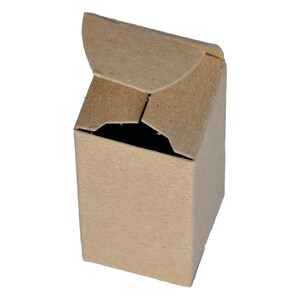 May include: A small, brown cardboard box with a hinged lid that is partially open. The box is made of recycled paper and has a natural, rustic look.