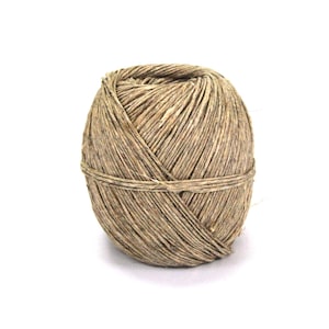 May include: A ball of natural twine made from brown fibers. The twine is tightly wound and has a rough texture.