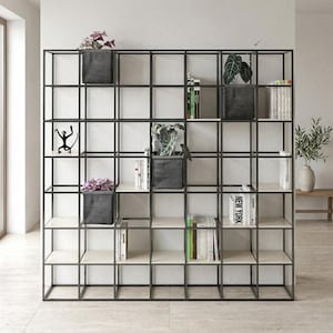 May include: A modern black metal and wood shelving unit with a grid design. The shelves display books, potted plants, and decorative items. The unit is a stylish storage solution for a living room or office.