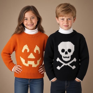 May include: Two long-sleeved knit jumpers featuring ribbed crew necklines and cuffs. One jumper is orange with a cream-coloured jack-o'-lantern face design, and the other is black with a white skull and crossbones graphic, both worn over white turtlenecks.
