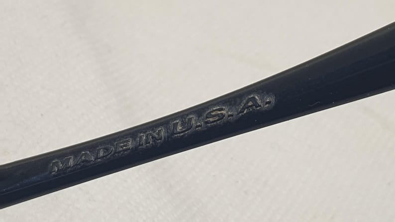 Puede incluir: Primer plano de un objeto negro con el texto "MADE IN U.S.A." grabado en la superficie. El objeto parece ser parte de un art&iacute;culo m&aacute;s grande, posiblemente una herramienta o accesorio.