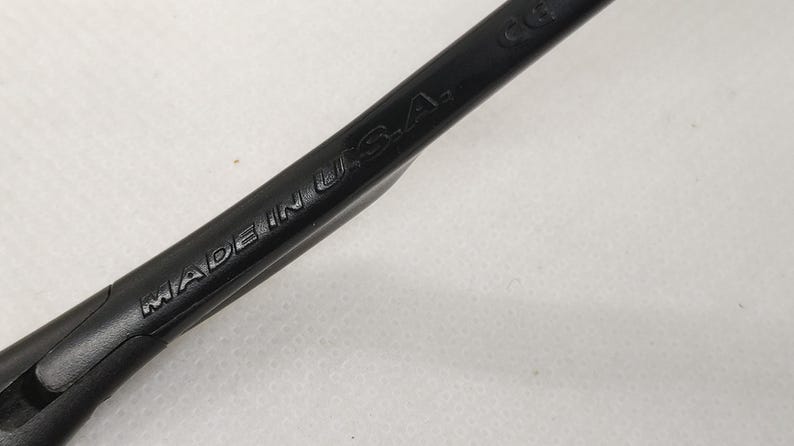 May include: Close-up of a black tool with the words "MADE IN U.S.A." embossed on its surface. The tool appears to be made of a durable material and is angled diagonally across the frame.