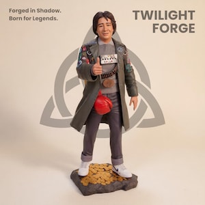 May include: A figurine of a man in a long green coat, gray shirt, and gray pants, holding a red bag. The figurine is standing on a base of gold coins. The text "TWILIGHT FORGE" is visible.