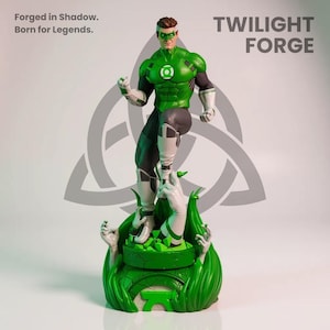 May include: A Green Lantern action figure stands on a green base with white hands reaching up. The figure is wearing a green and black costume with a white mask. The text "Forged in Shadow. Born for Legends." is visible.