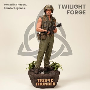 May include: A detailed figurine of a soldier in military attire, holding a rifle. The figure stands on a base with the text "Tropic Thunder." The image includes the text "Forged in Shadow. Born for Legends." and "Twilight Forge."