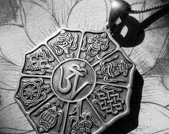 May include: A silver-colored pendant necklace with an intricate, octagonal design. The pendant features detailed carvings of symbols and a central Om symbol. The necklace is displayed on a background with a lotus flower sketch.