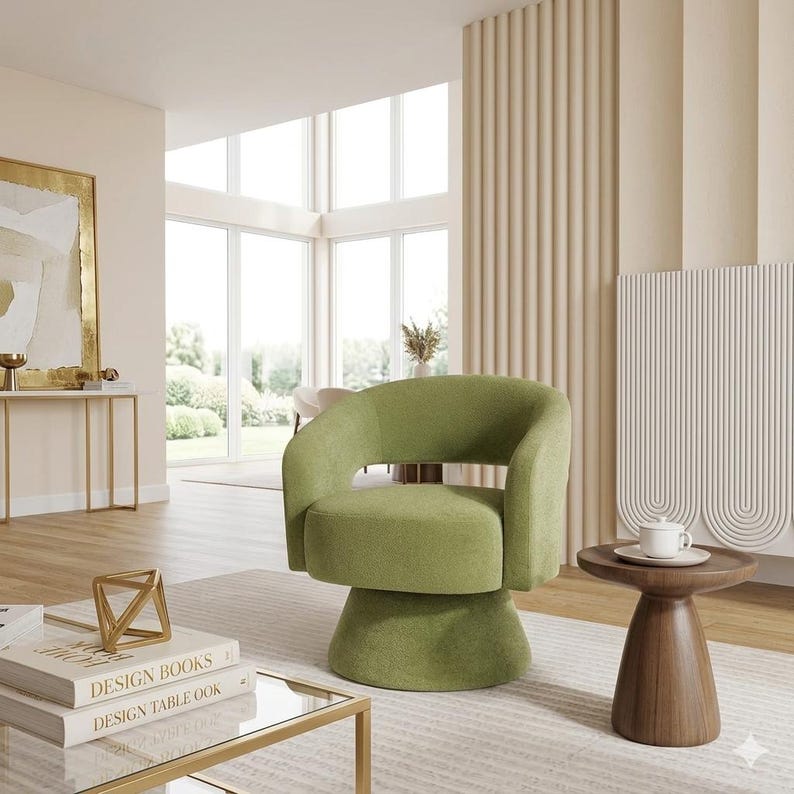 May include: A modern, olive green swivel chair with a rounded back and armrests. The chair sits on a pedestal base. A small, round, wooden side table with a white teacup and saucer is next to the chair. The room has a neutral color palette.