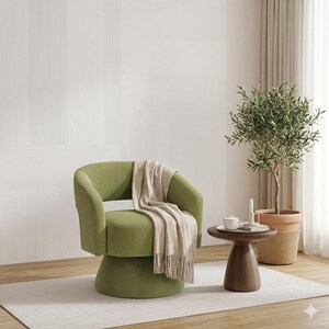 May include: A green swivel armchair with a beige throw blanket draped over it. A small, round wooden side table holds a white teacup and saucer. A potted olive tree sits nearby, creating a cozy interior design scene.