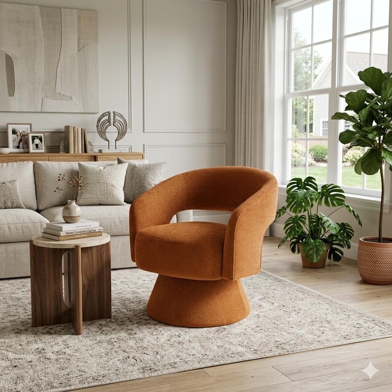 May include: An orange swivel chair with a rounded back and armrests. The chair sits on a pedestal base. The chair is in a living room setting with a sofa, side table, and plants.