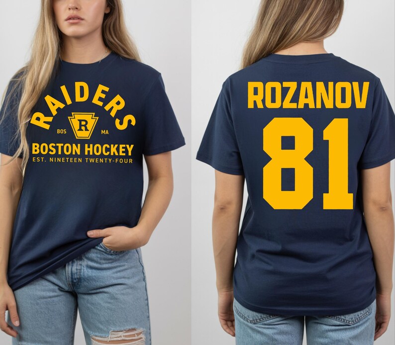 May include: Navy blue t-shirt with "RAIDERS BOSTON HOCKEY" text in yellow. The front of the shirt has a crest with the letter "R". The back of the shirt has the name "ROZANOV" and the number "81" in yellow.