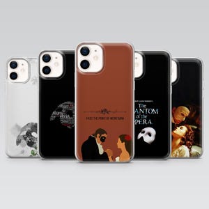 May include: A collection of phone cases featuring designs inspired by "The Phantom of the Opera." The cases display various graphics, including the iconic mask, opera house silhouettes, and character illustrations. Text includes "Phantom Opera" and "Past the Point of No Return."