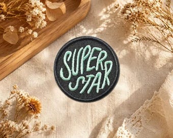 Round Mint Cursive Text Embroidered Iron‑On Patch, Black Background Hand‑Script Badge, Casual DIY Clothing Repair Applique.